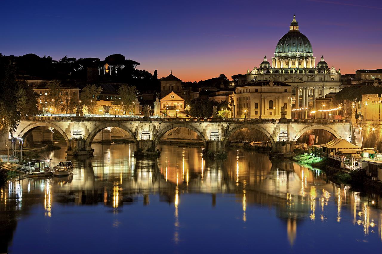 Historic Rome cityscape with ancient ruins and domes under blue sky